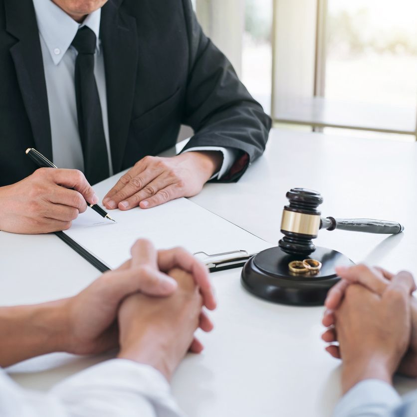 Agreement prepared by lawyer signing decree of divorce (dissolution or cancellation) of marriage, husband and wife during divorce process with male lawyer or counselor and signing of divorce contract